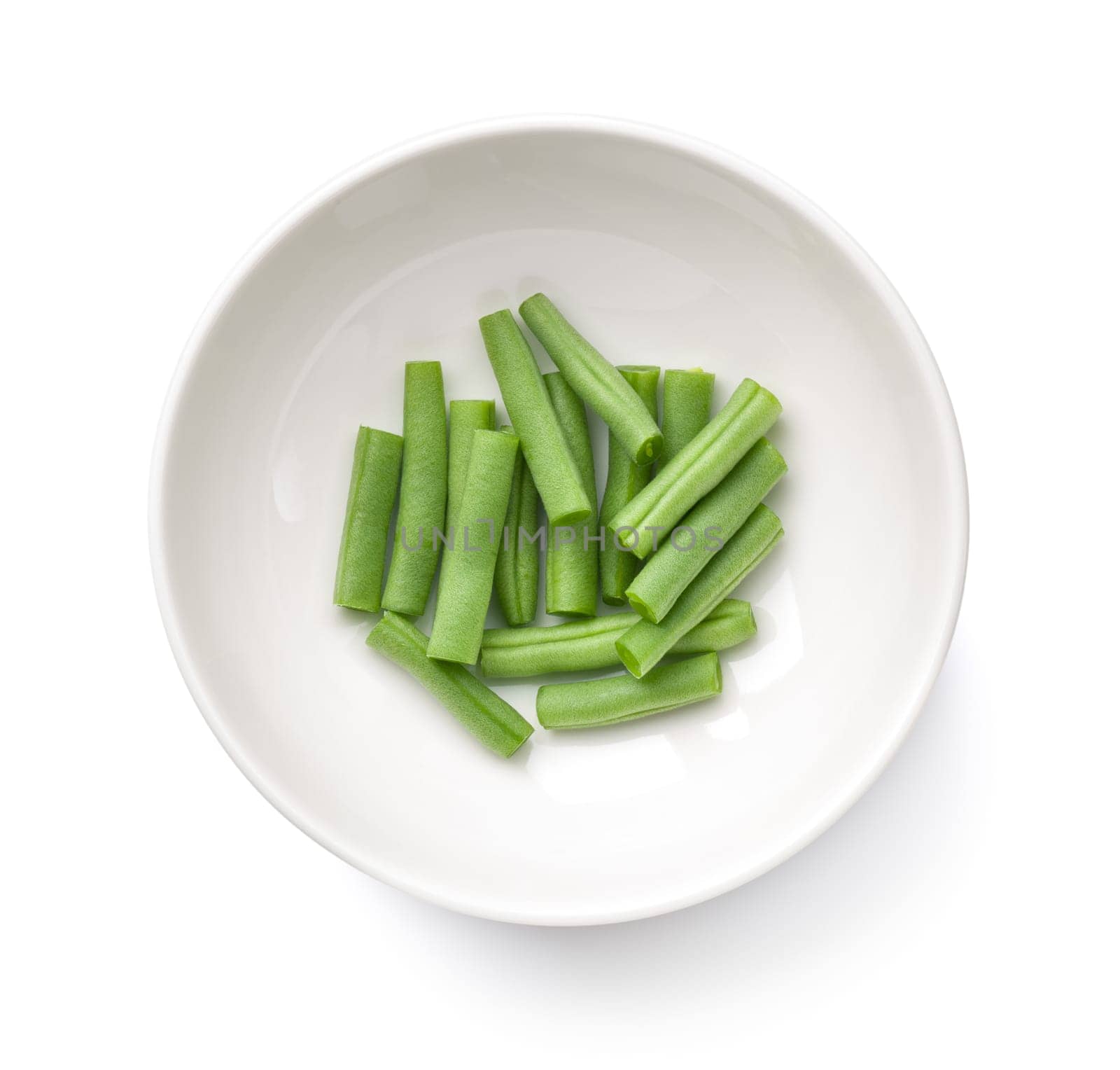 Chopped green beans in white bowl isolated over white background. Top view