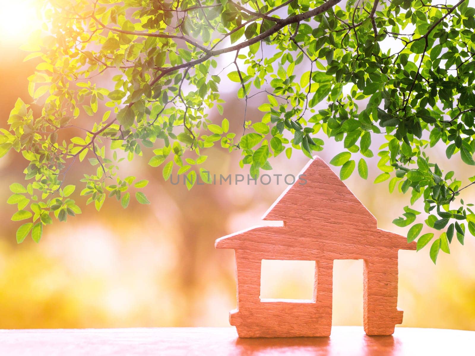Sunshine through wooden House model there space. home, housing and real estate concept