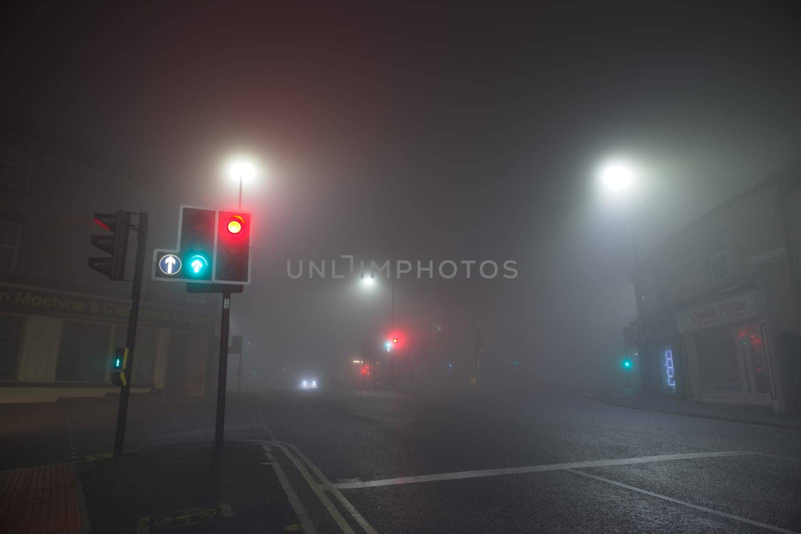 Sheffield, United Kingdom, 8th November, 2020: Very heavy fog at a crossroads in broomhill. Looking along fulwood road, traffic light in foreground.