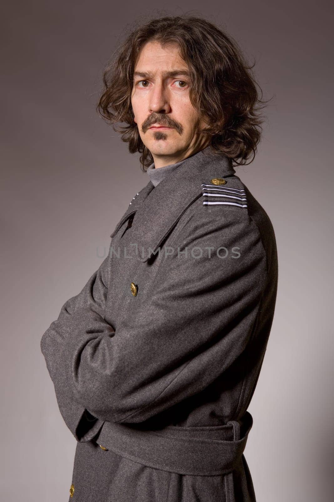 young man dressed as russian military, studio picture