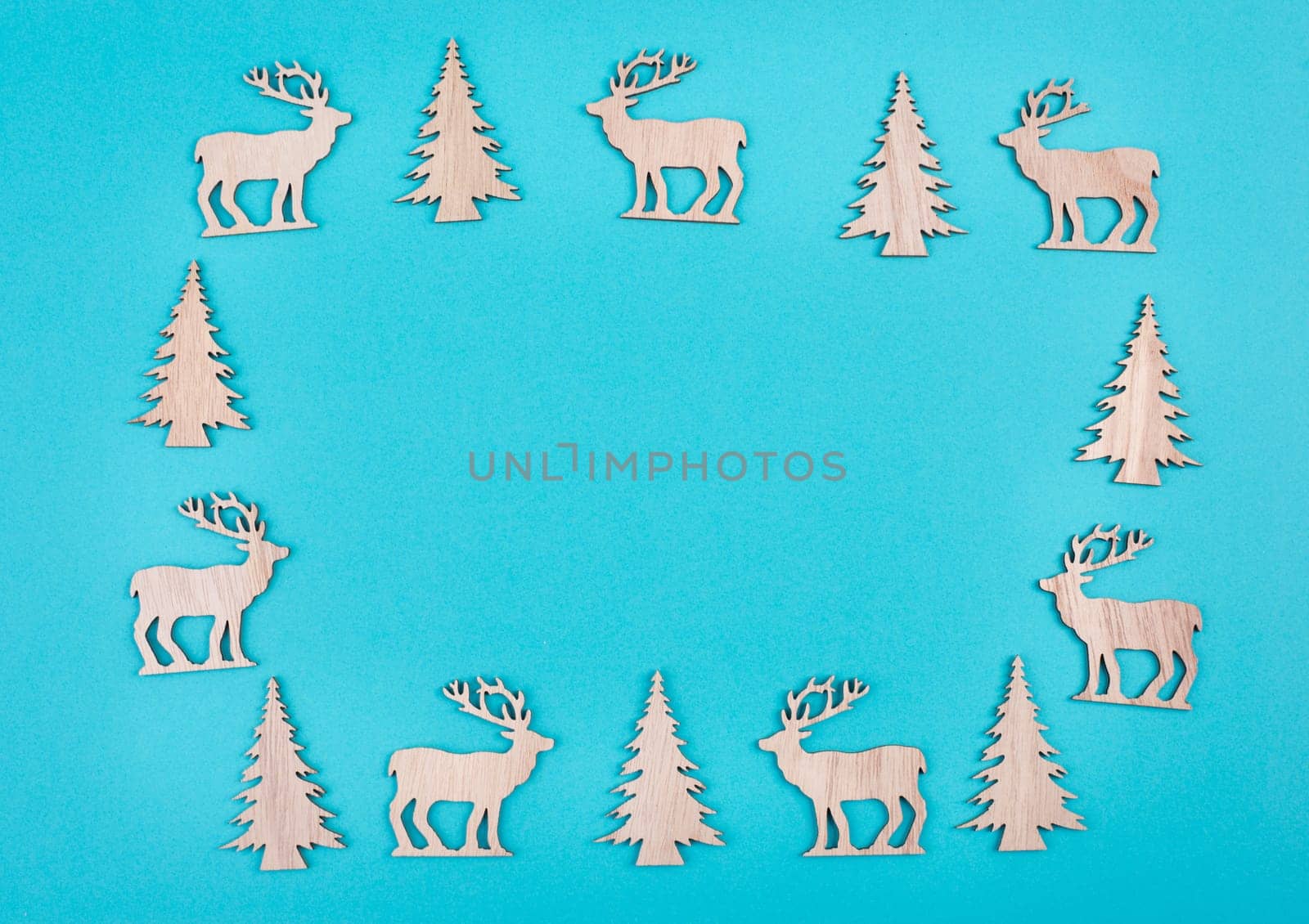 Reindeers, christmas trees, blue colored background, copy space for text, greeting card, winter backdrop