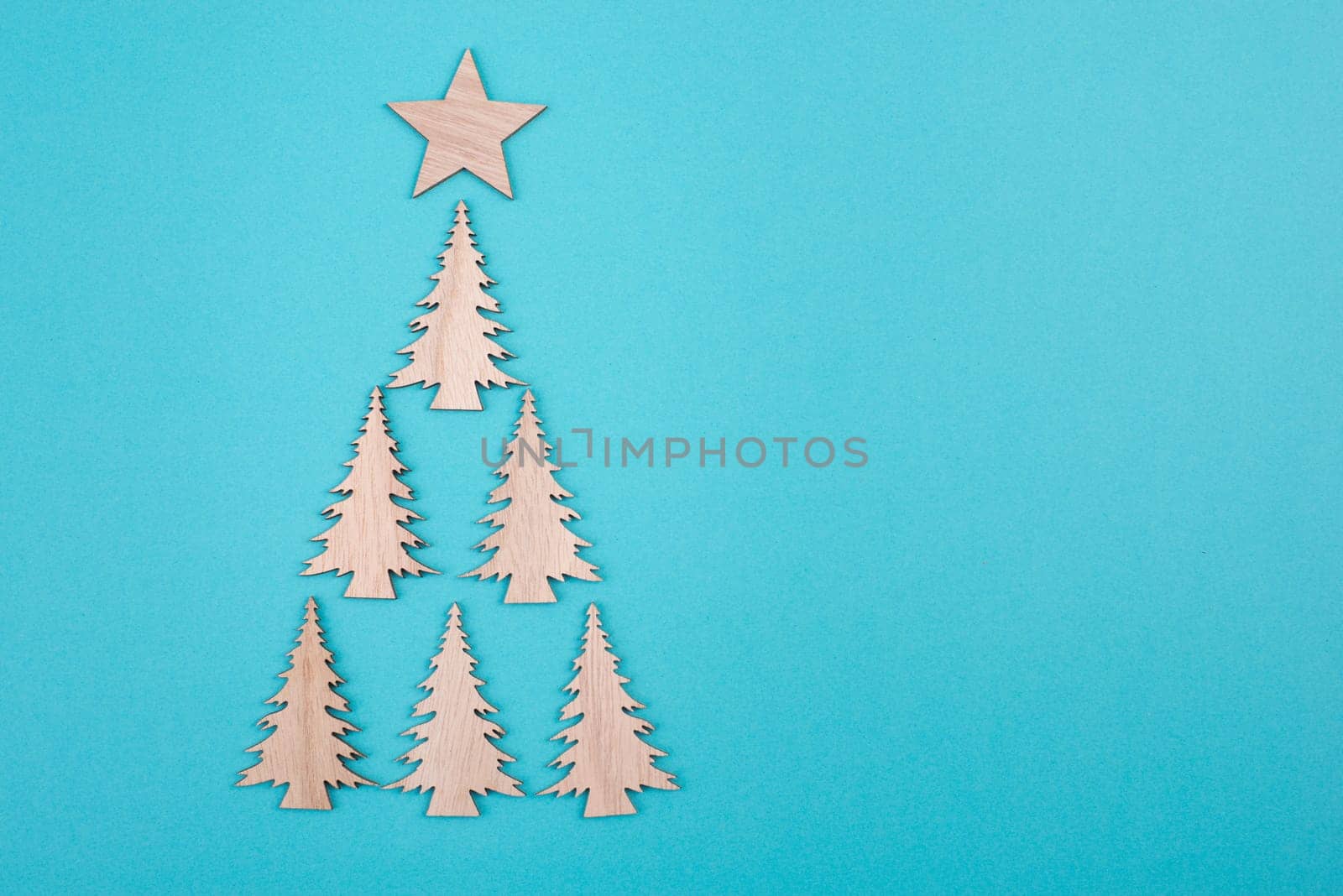 Christmas tree on a blue background, greeting card, festive background, copy space, wintertime, happy holidays