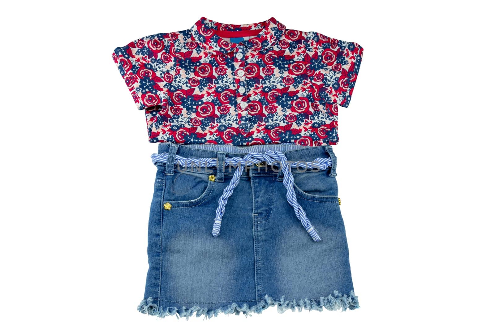 Jeans skirt. Close-up of a sexy short blue jeans skirt with blue white linen twine and a fashionable little girl shirt with floral print isolated on a white background. Denim fashion for girls.