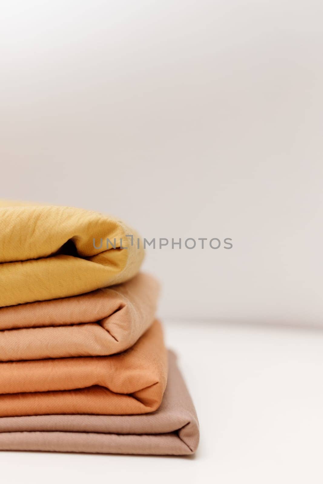 Stacks colorful cotton fabric, clothes. Copyspace