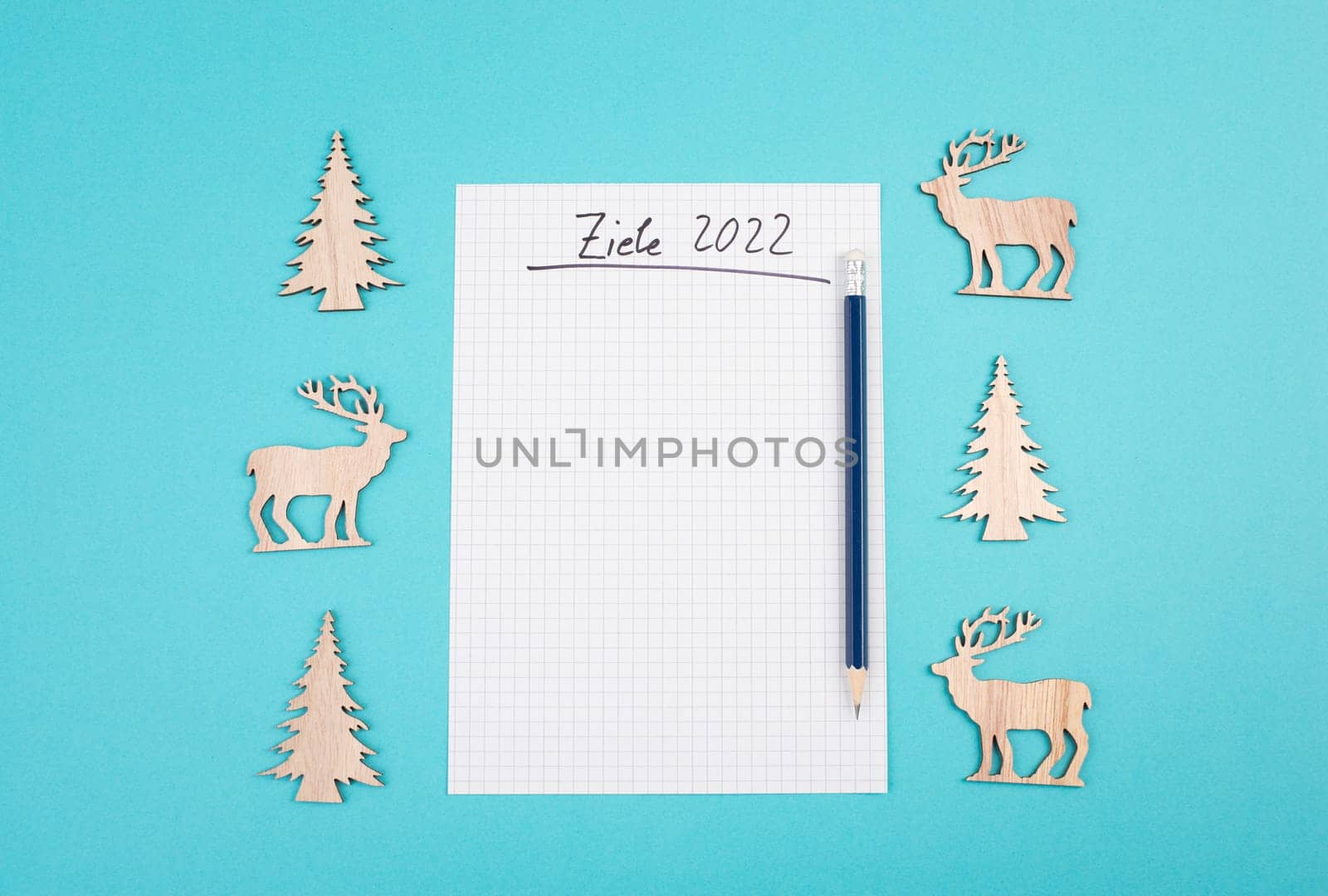 Goals 2022, empty paper, christmas time, making plans for the new year, copy space, blue colored background, german language