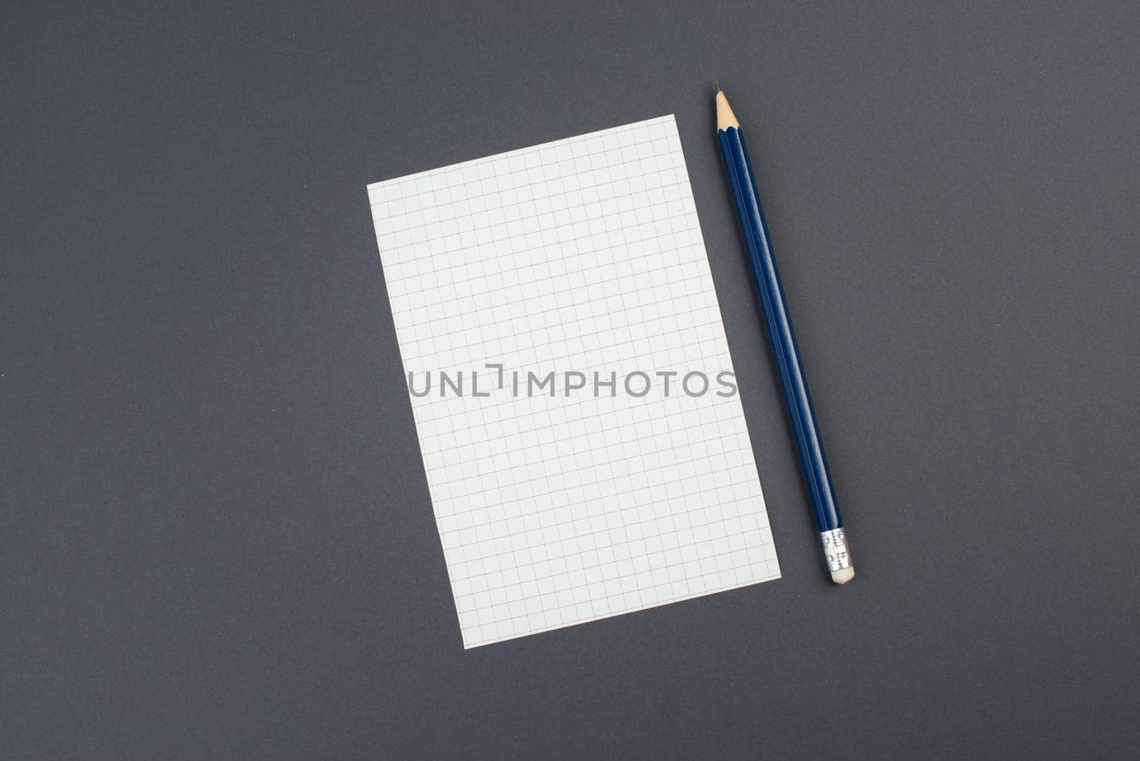 Empty paper with a pen on a dark grey background, copy space for text, busisness concept, education, minimalism