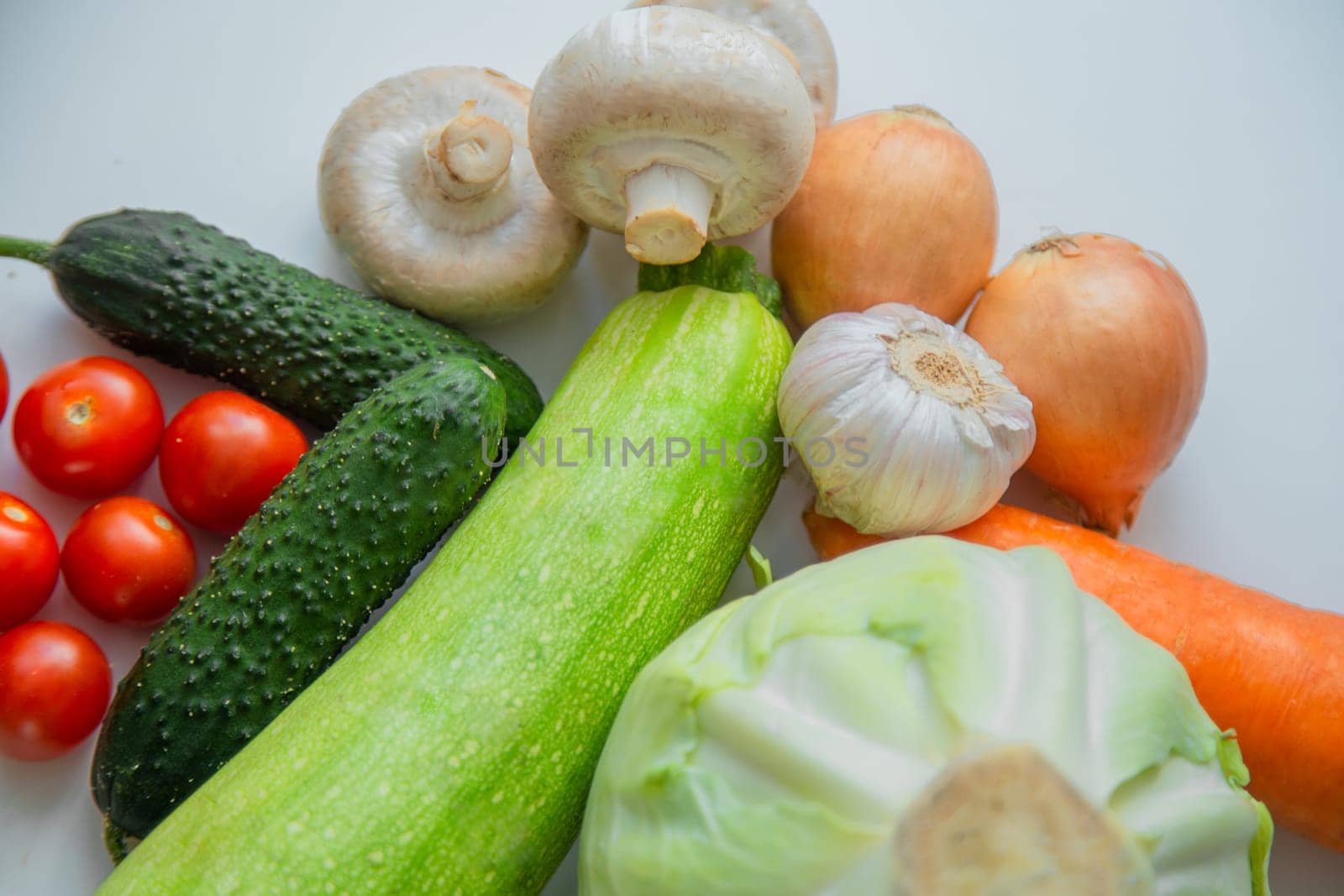 Vegetables and porcini mushrooms lie on a white background. High quality photo