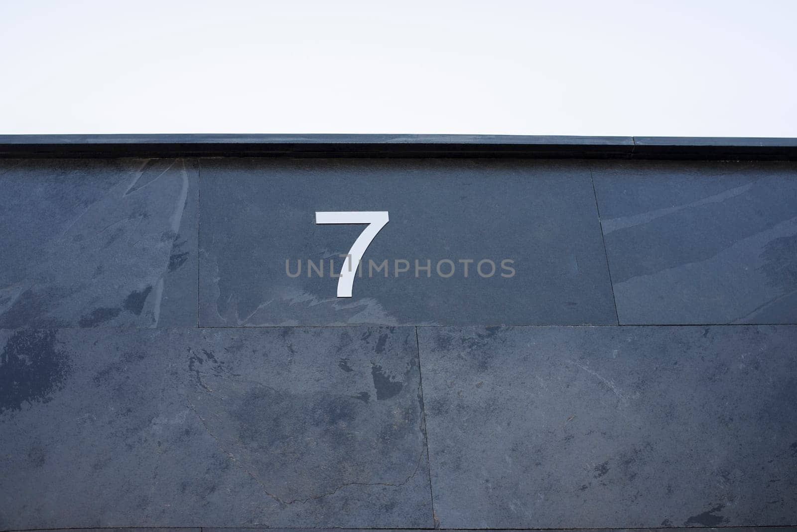 House number 7. Silver over black-blueish slate. Houses with personality concept