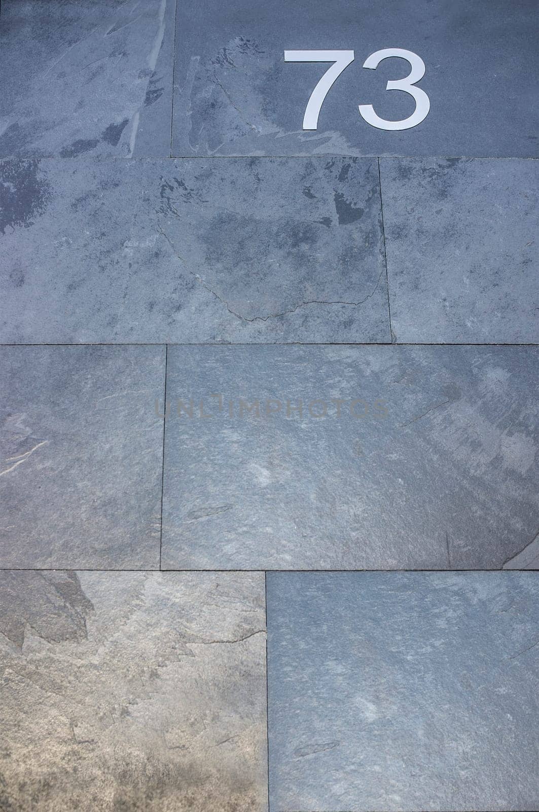 House number 73. Silver over black-blueish slate. Houses with personality concept