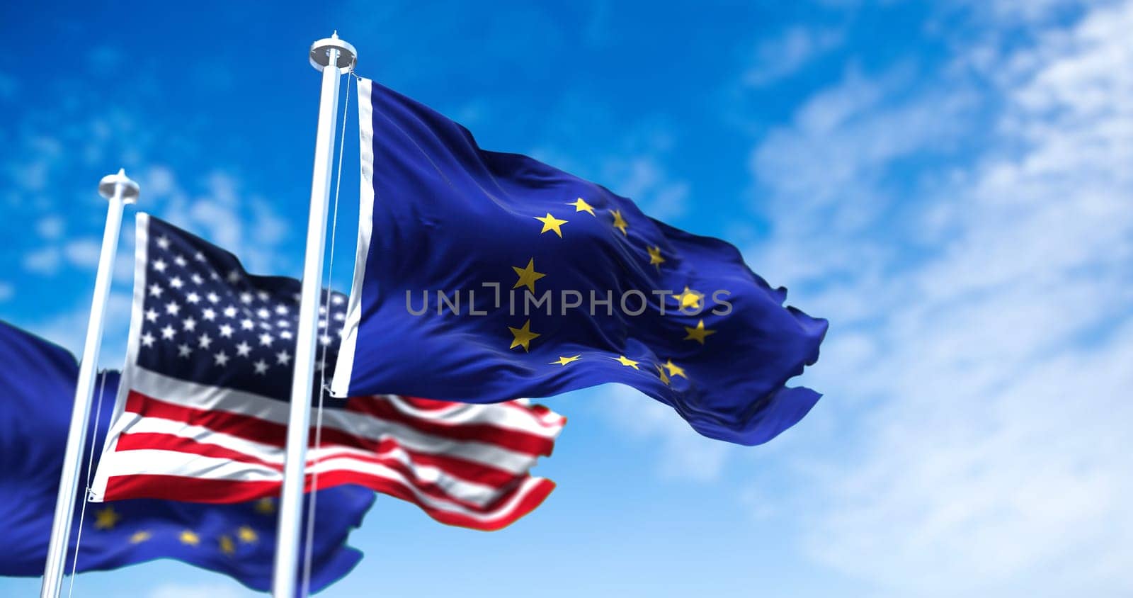 The flags of the European Union and the United States of America waving in the wind. International relations and diplomacy.