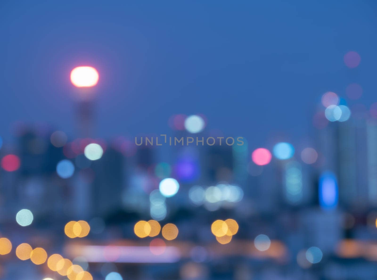 Blurred twilight bokeh lights city office building, abstract background