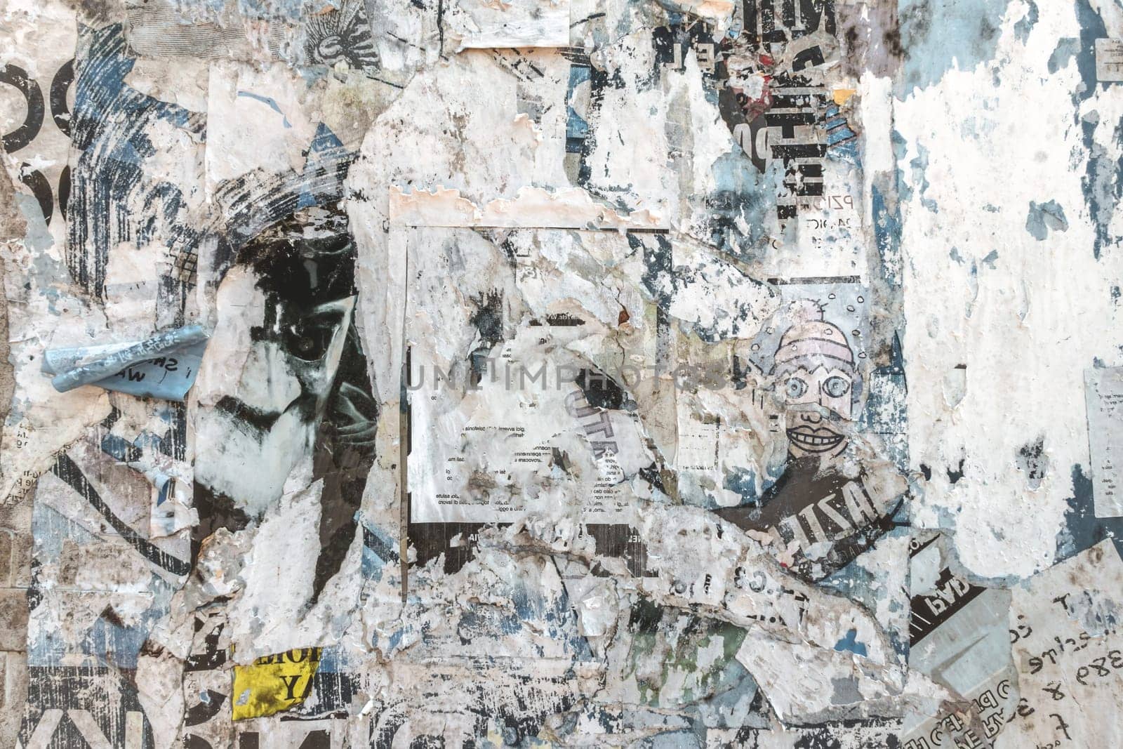 Grunge background with old torn posters. Multicolor texture.