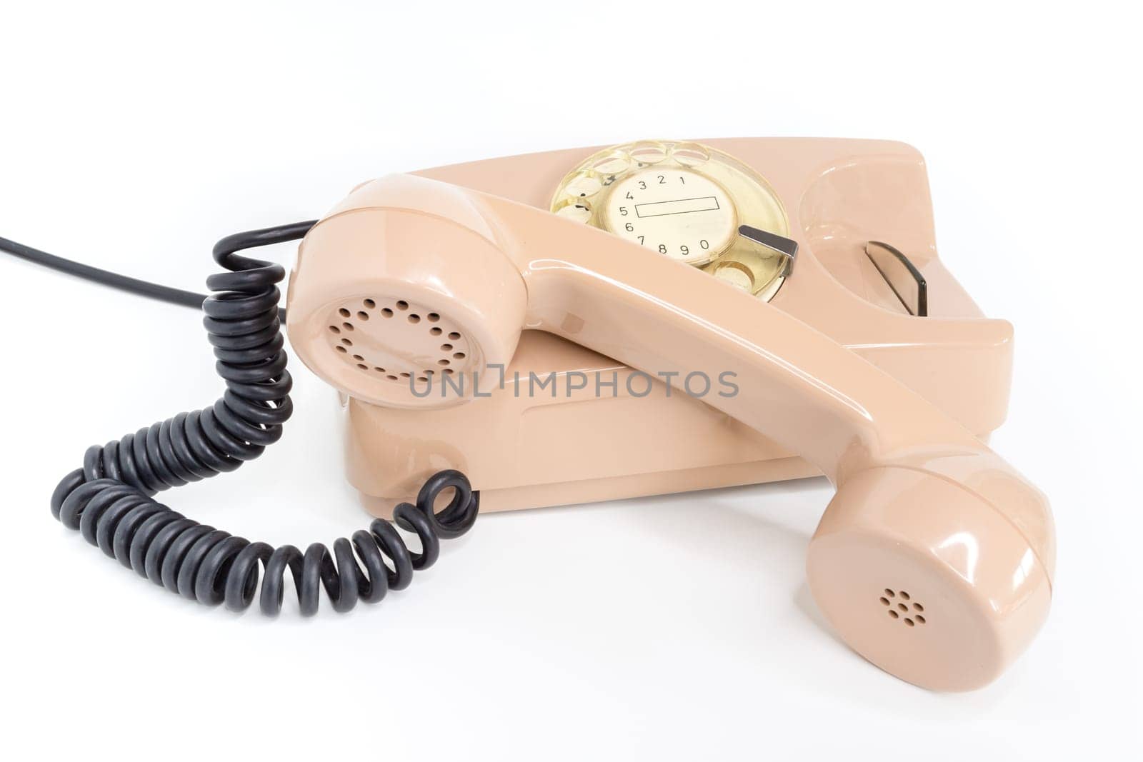 Vintage telephone. Pink old telephone isolated on white background.