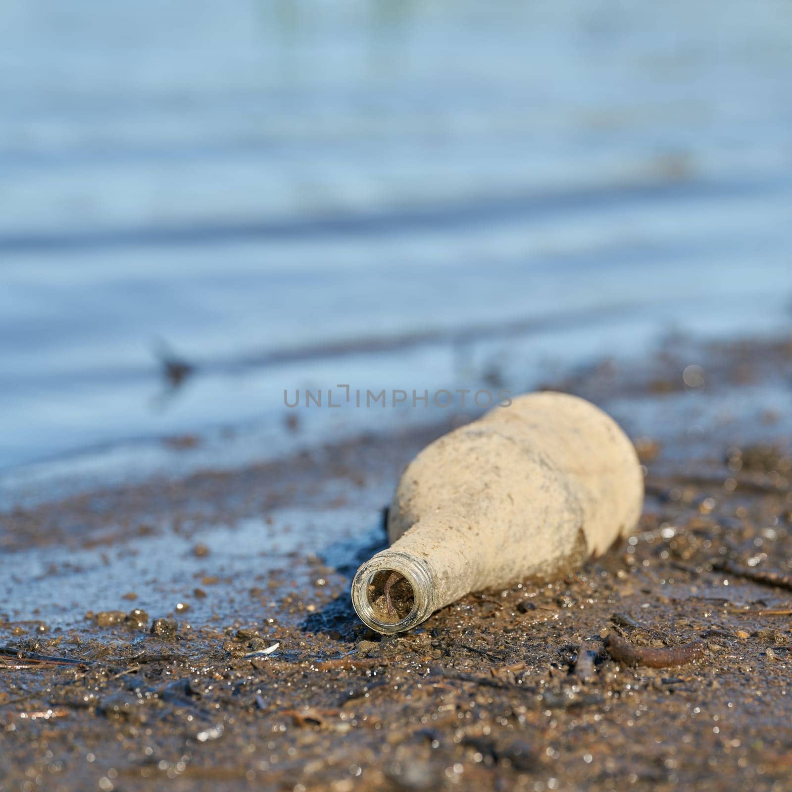 Bottle made of glass on the banks of the Elbe in Herrenkrug Park near Magdeburg