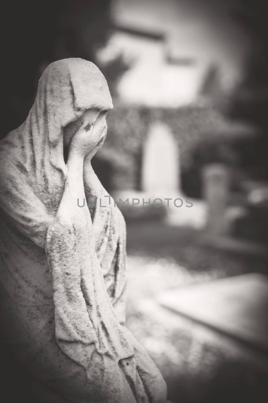 Suffering young woman. Statue of a desperate woman. Defocused blurry background. Retro style photo.