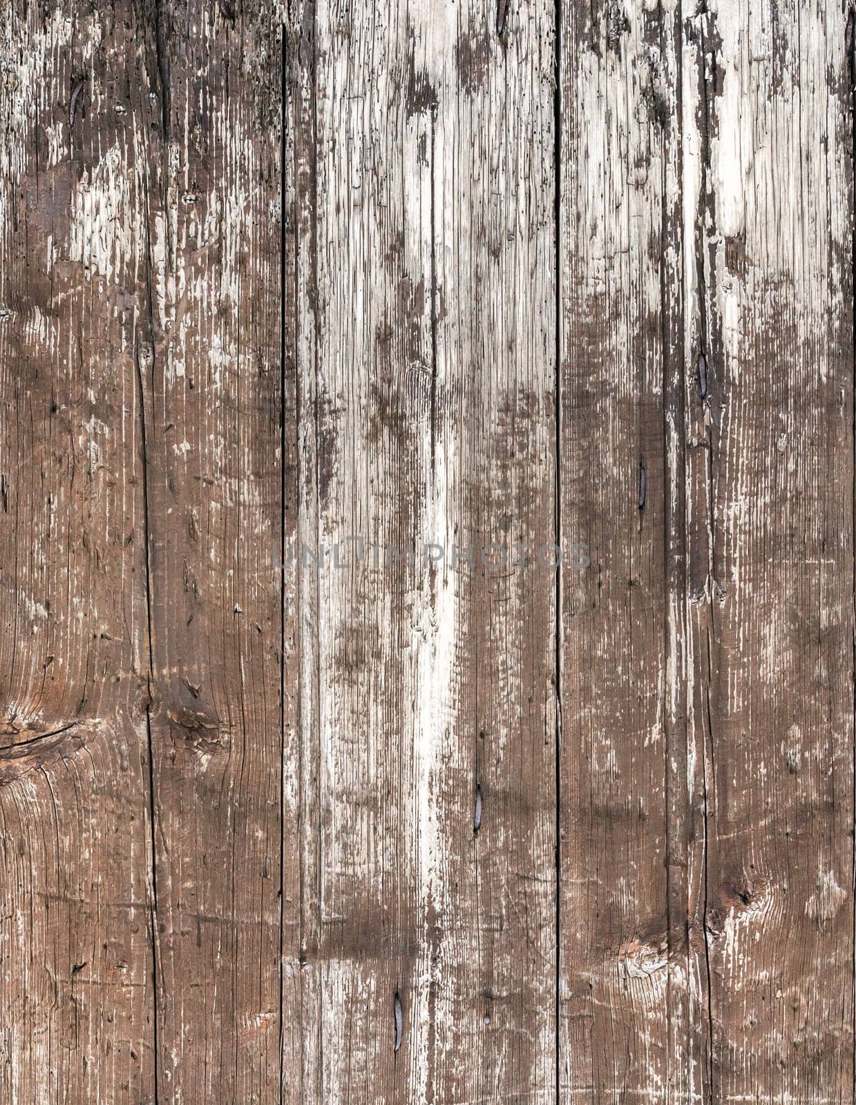 Vertical wooden planks. Close- up of a wall made of old wooden planks.