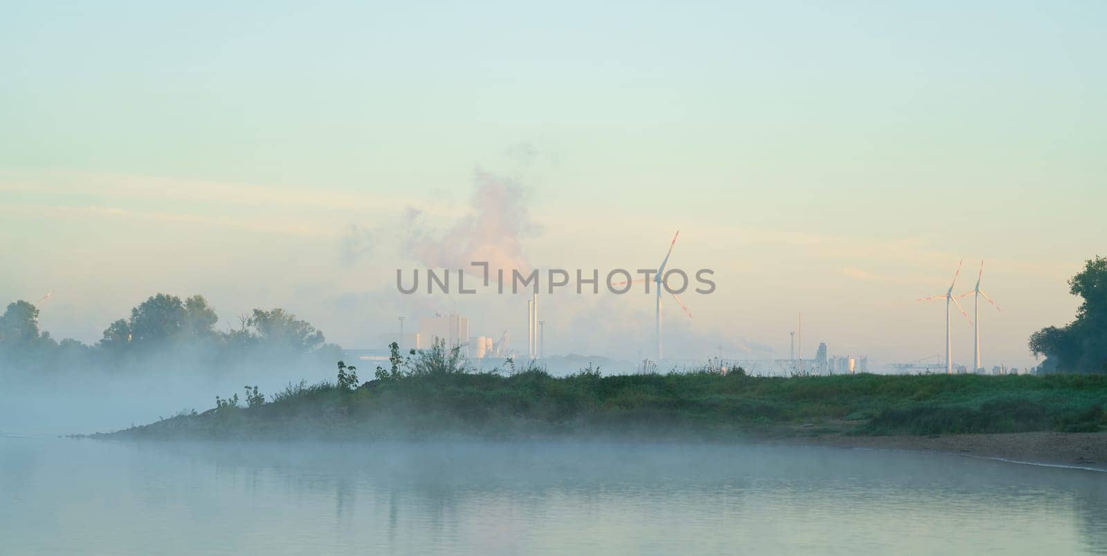 Industrial area Rothensee at the bank of the river Elbe at fog seen from Herrenkrugpark