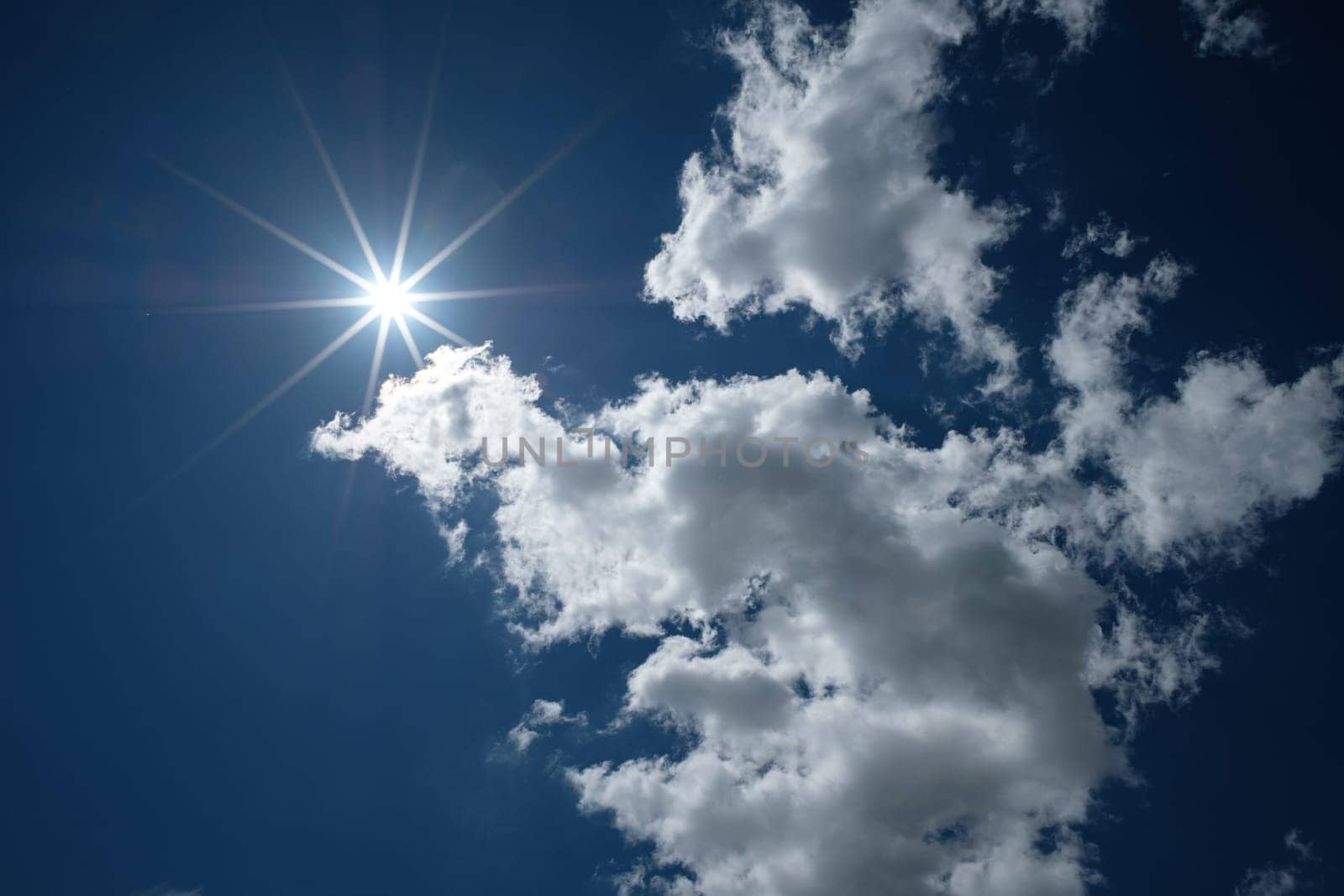 Sunlight with rays in the blue sky with clouds back lit