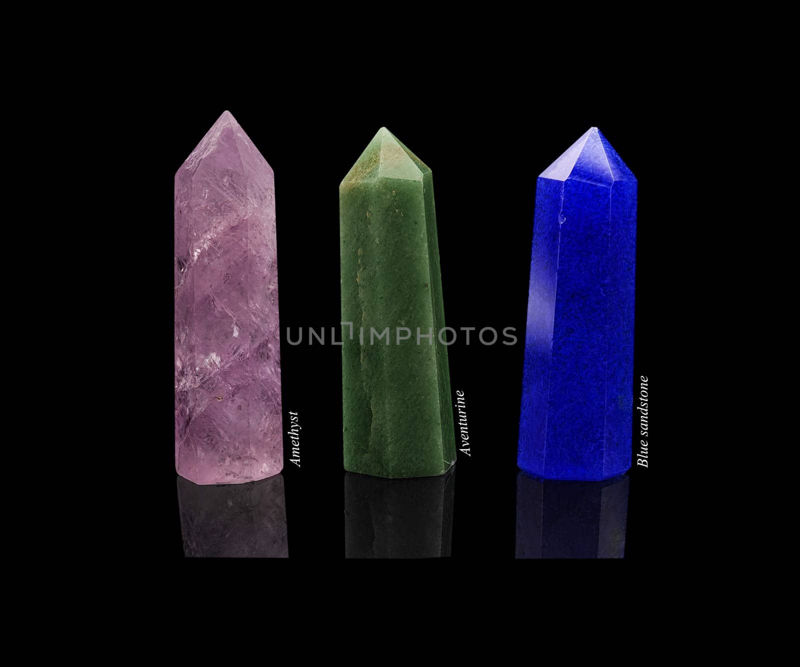 Set of crystals of semi-precious stones: amethyst, aventurine, blue sandstone with natural reflection isolated on black glossy background