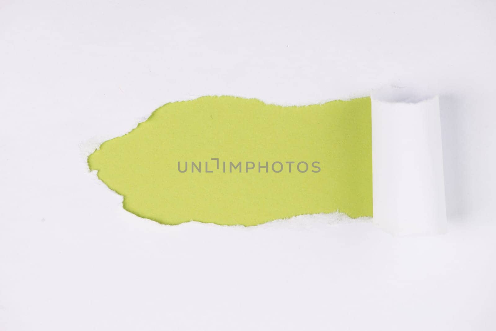 White torn paper, green background, empty copy space, ripped sheet