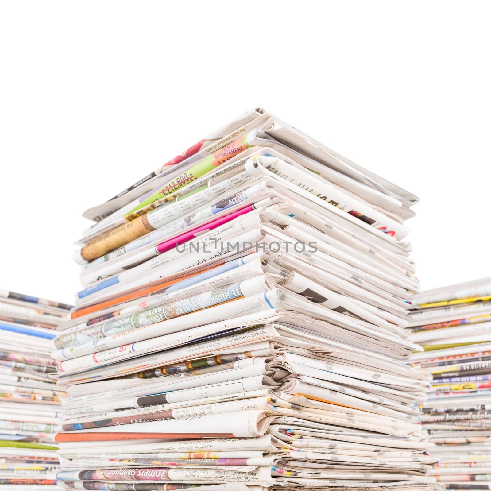 Three big stacks of newspapers isolated on white
