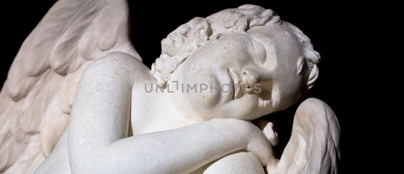 MILAN, ITALY - CIRCA AUGUST 2020: Cute sleeping angel. Statue made in marble, end of 18th century, unknown sculptor. Concept for sleep, innocence and newborrn.