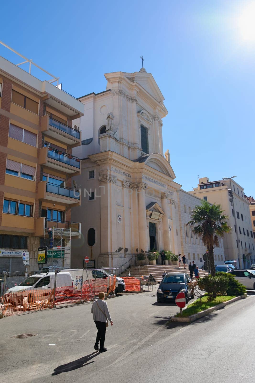 Civitavecchia. Italia - December 19, 2024: A sunny day in Civitavecchia, Italy, featuring a historic church and urban surroundings. Concept: History, modernity, cityscapes.
