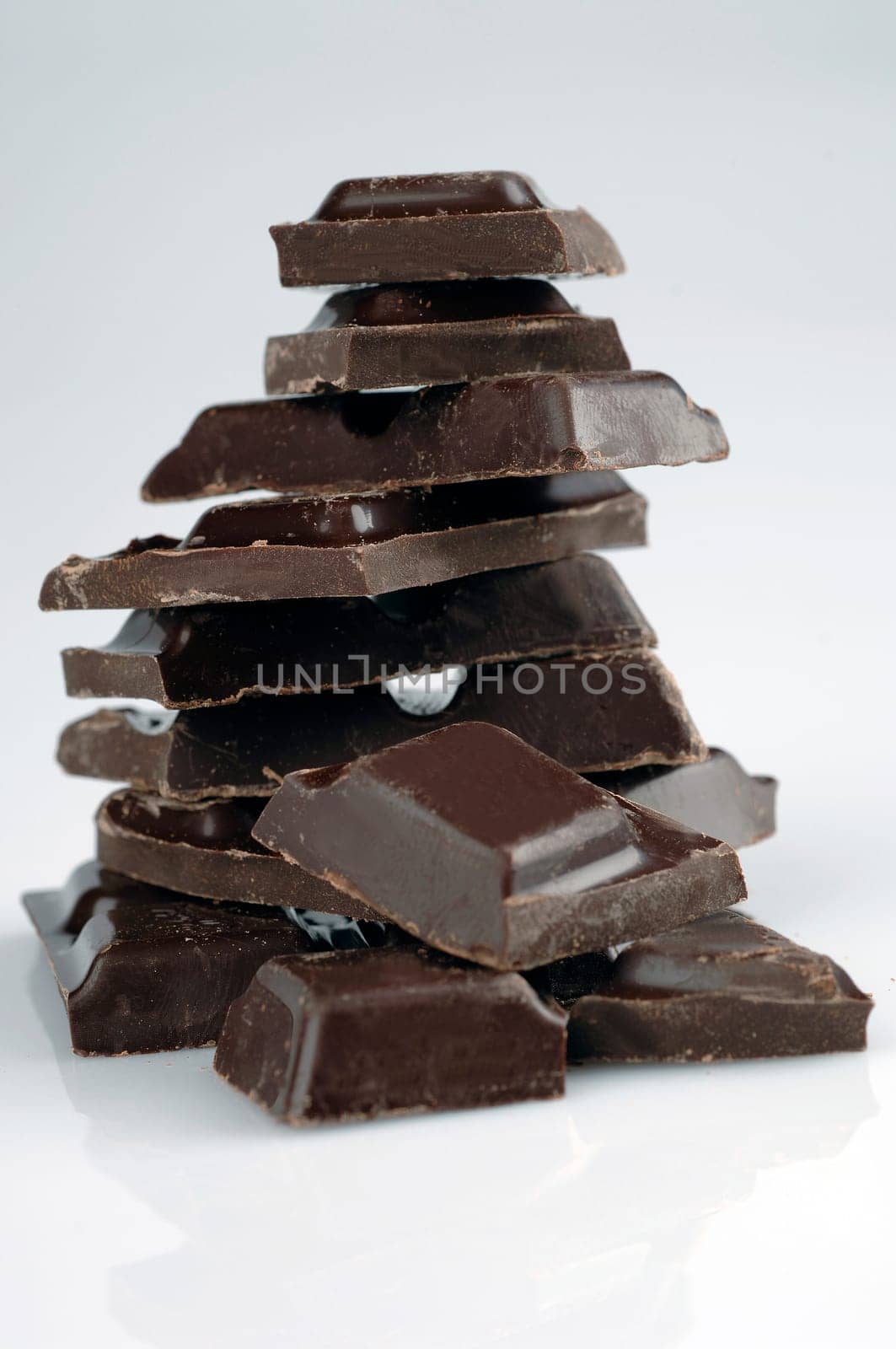 cubes of black chocolate on a white background