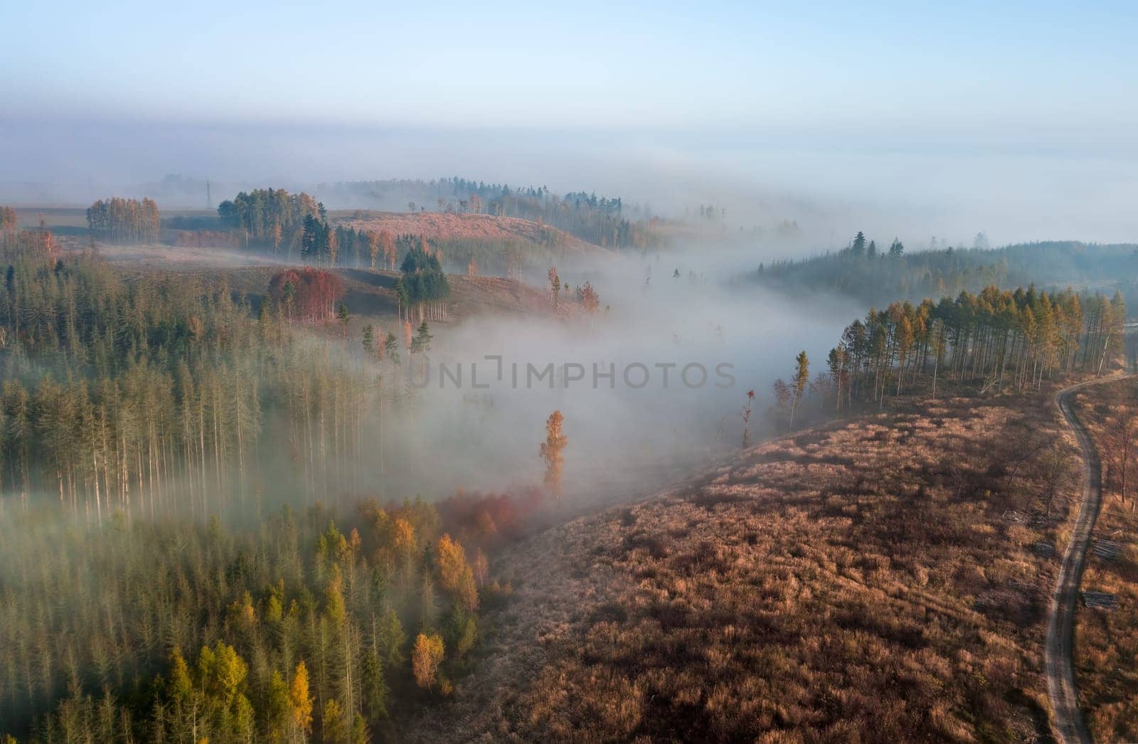 Aerial view of autumn sunrise countryside, traditional fall landscape with rising sun in Central europe. Foggy and misty sunrise. Frozen landscape from bird eye. Czech Republic,Vysocina highland