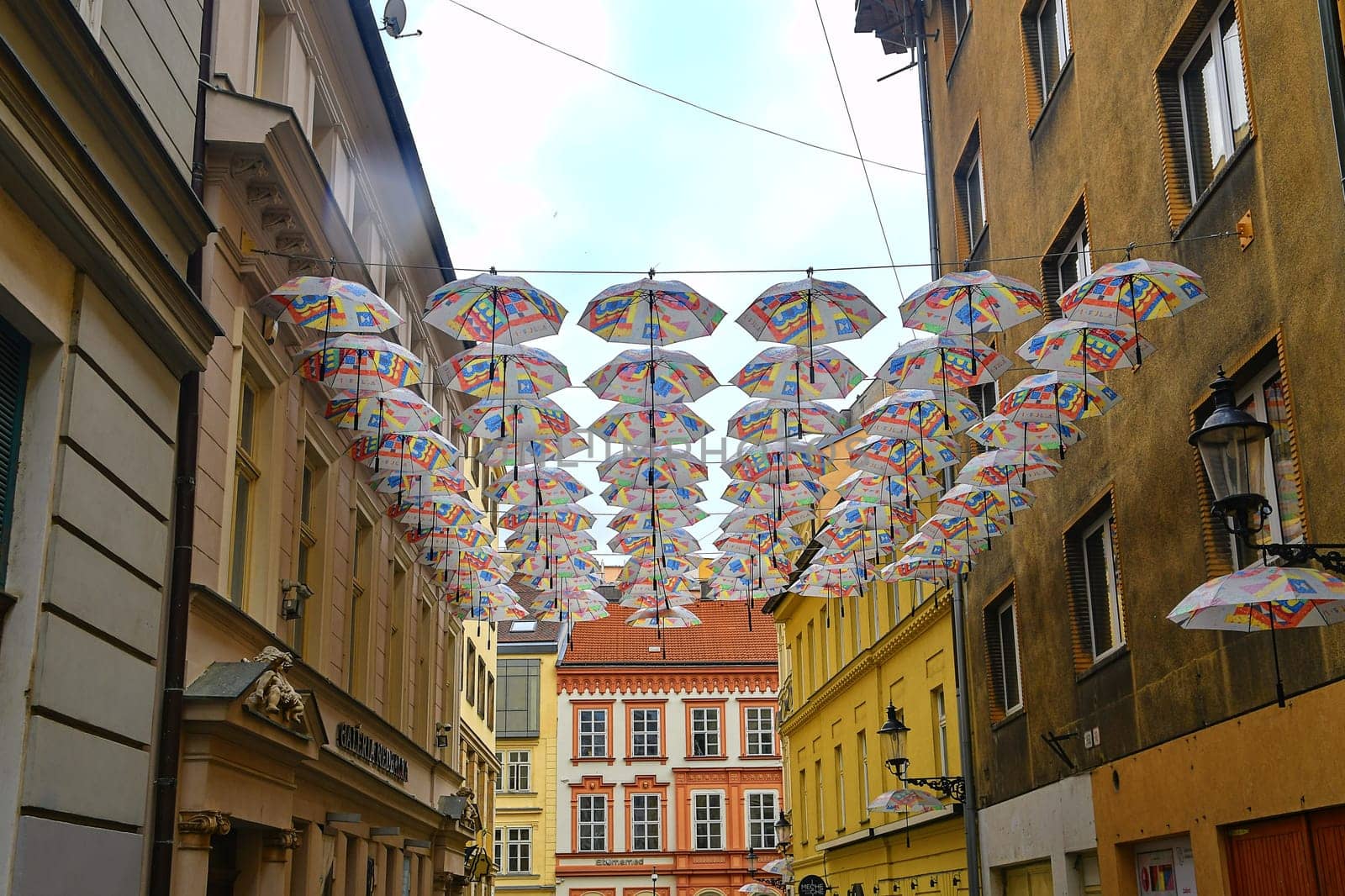 BRATISLAVA, SLOVAKIA - JUNE 8, 2020: Umbrellas above the street in Bratislava's Old Town district. Umbrellas hang in rows on the street as a decoration.