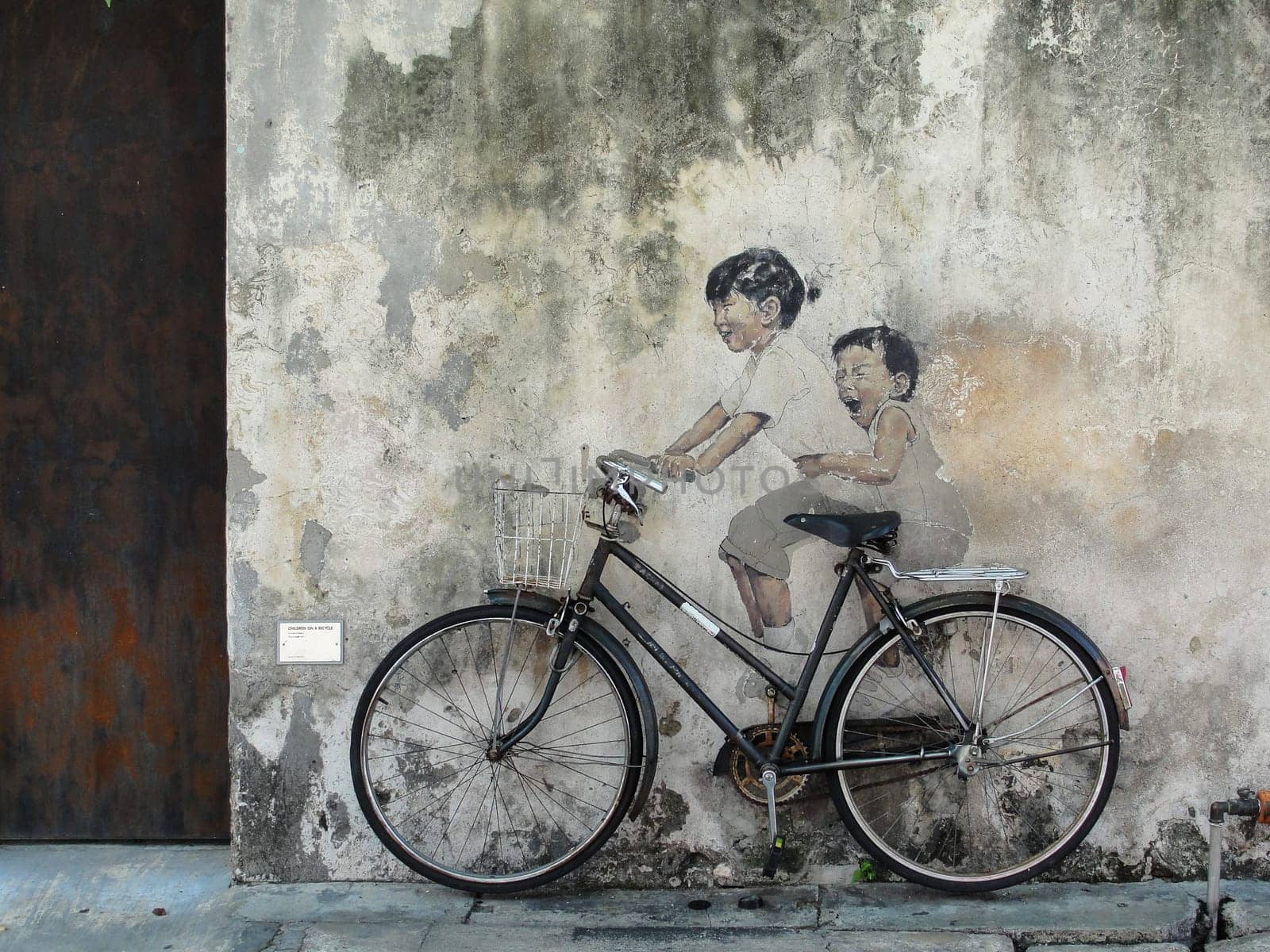 Little Children on a Bicycle street art on wall by Lithuanian artist Ernest Zacharevic in George Town, Penang, Malaysia, travel photo