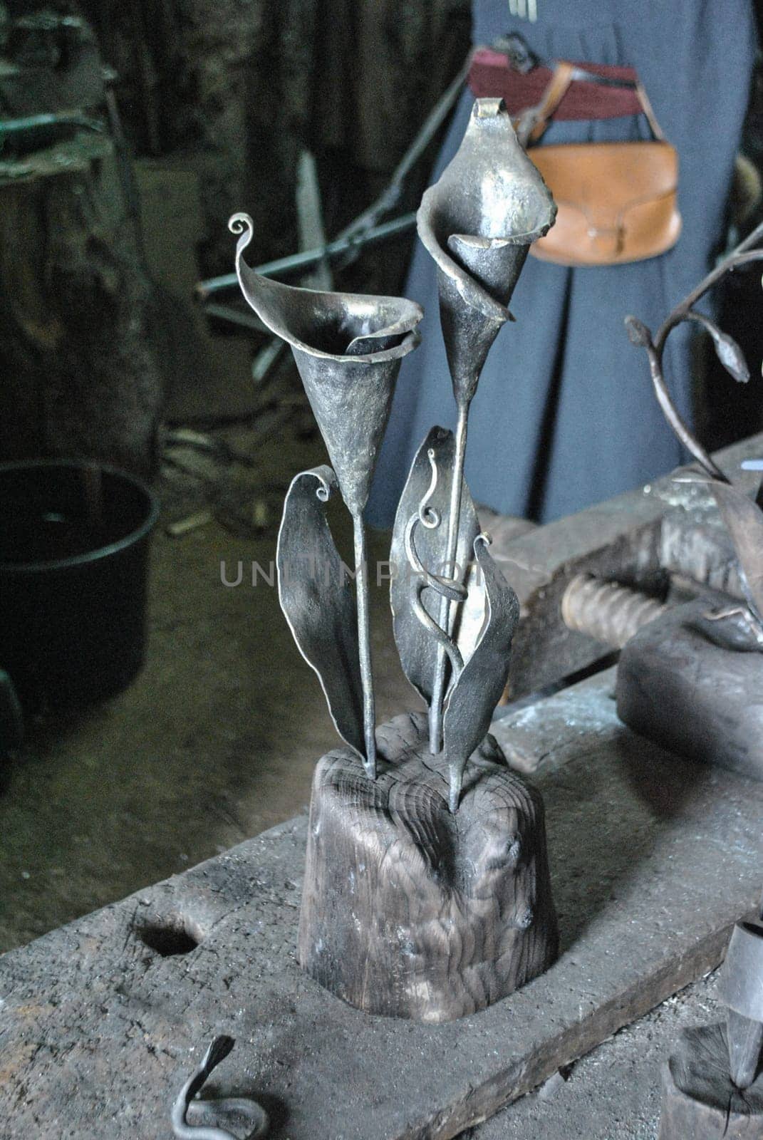In the workshop at the blacksmith's flower calla forged from metal
