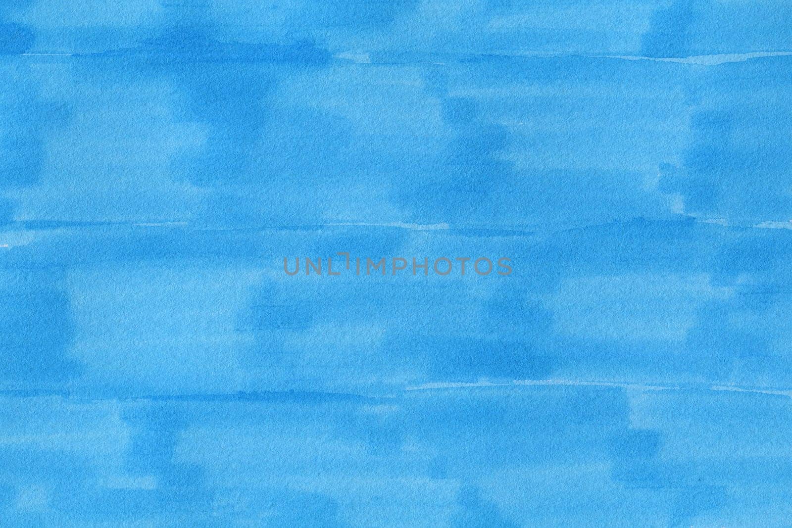 closeup macro of permanent blue marker doodles brushes on white background paper with visible surface fiber structure details