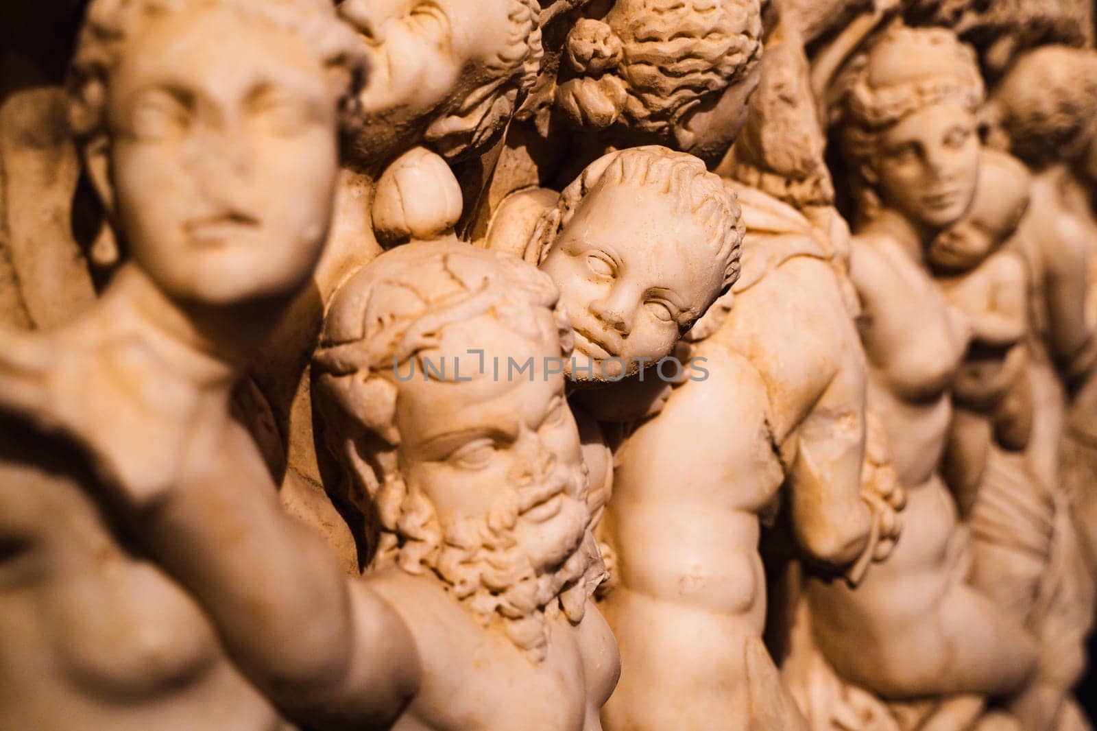 side view detail of stone statues basorelief scene on ancient sarcophagus in Antalya archeological museum