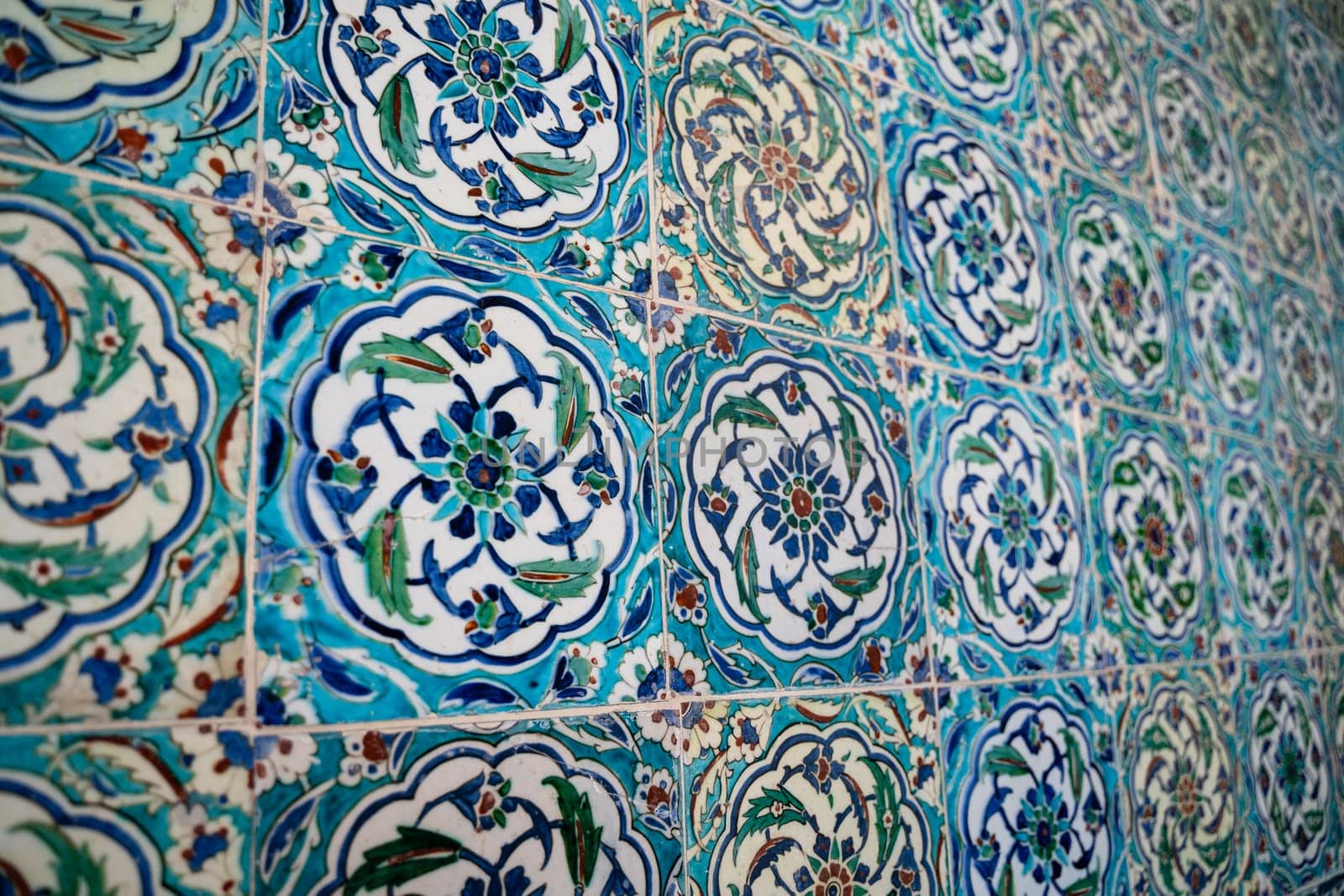front view close up of Islamic ottoman era blue ceramic ornament tiles with flowers in Topkapi Palace museum Istanbul