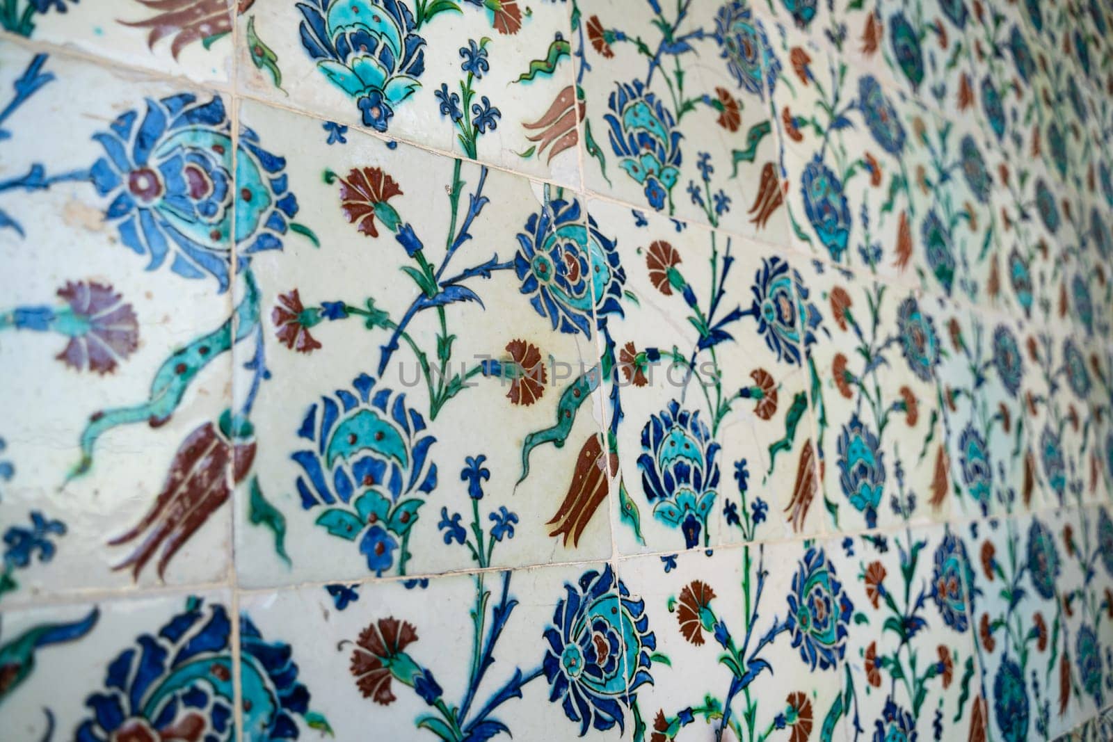 front view close up of Islamic ottoman era blue ceramic ornament tiles with flowers in Topkapi Palace museum Istanbul