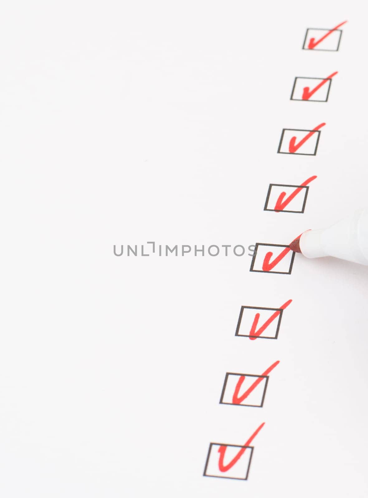 Red colored checkmarks in little black boxes, white paper, education, test, to do list, busniss concept
