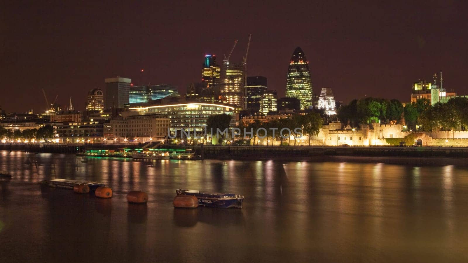 London, United Kingdom - October 7th, 2006: Riverside of Thames, with "Square Mile"" (Financial district - most of banks in the City) in background, photographed in night."