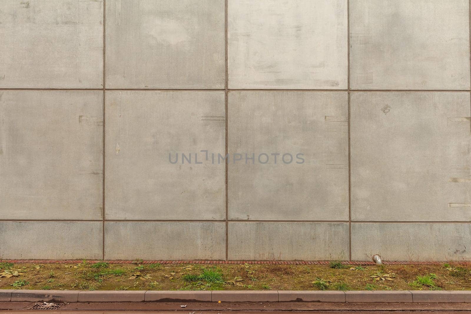 Gray concrete wall with lots of concrete shapes and grid lines