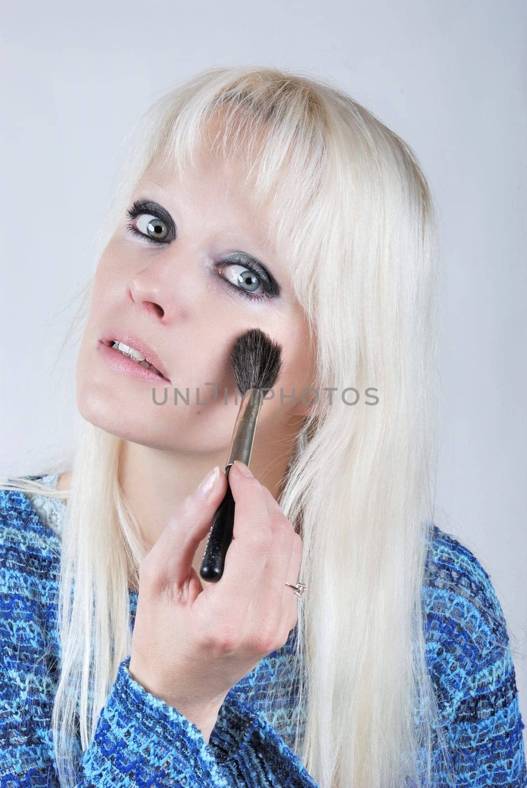 Woman applying makeup
