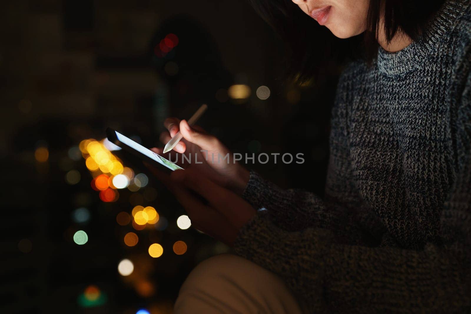 Using stylus pen on digital tablet at night, lifestyle at night in city