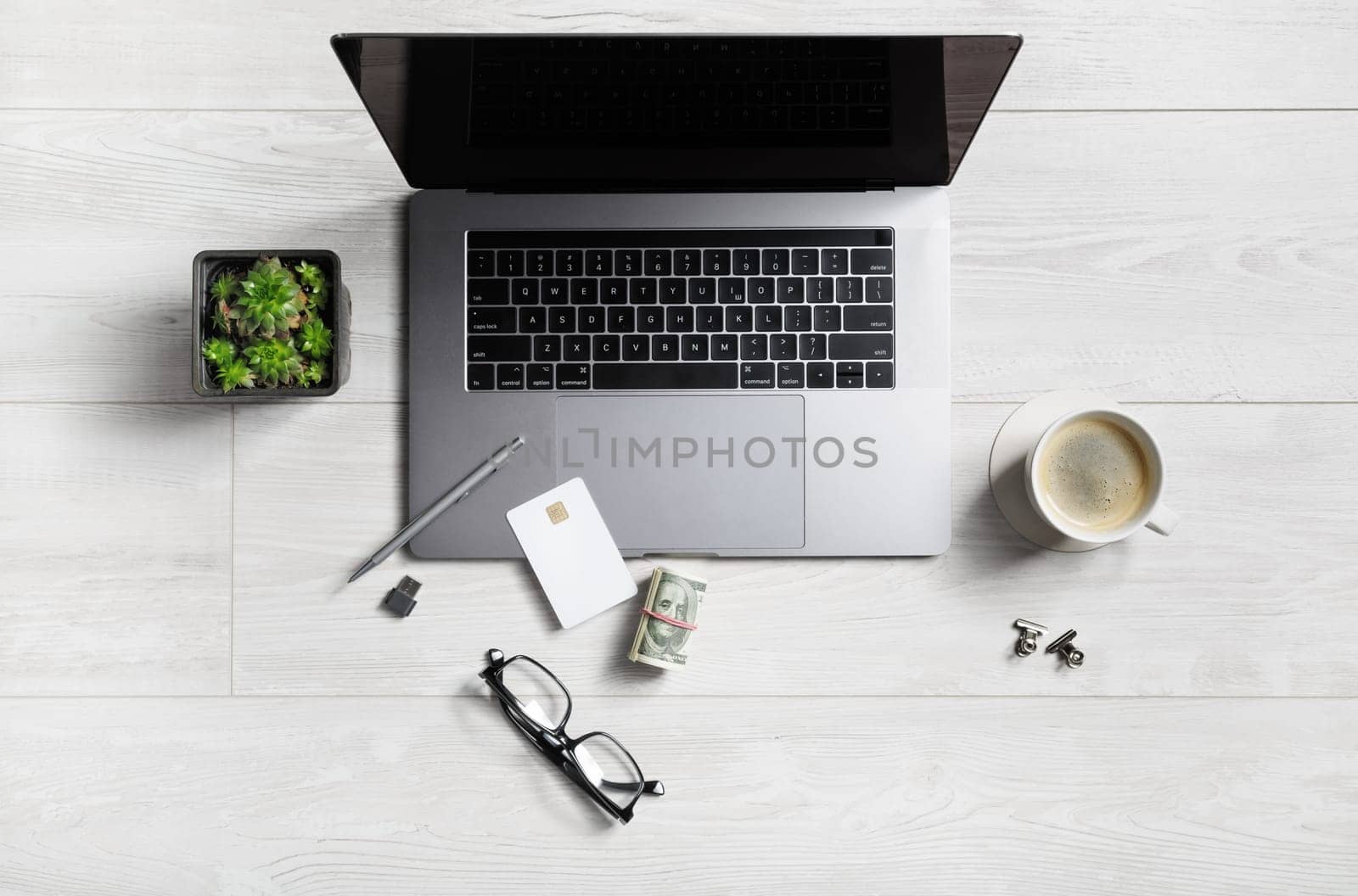 Online work concept. Office supplies and gadgets on wooden background. Flat lay.
