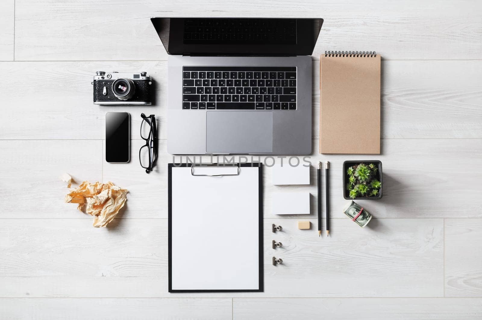 Mix of blank office supplies and gadgets on wooden background. Flat lay.
