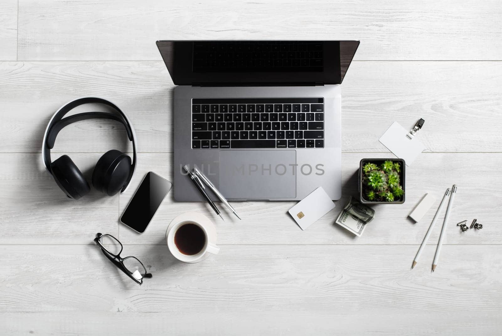 Office workspace with supplies and gadgets on wooden background. Flat lay.