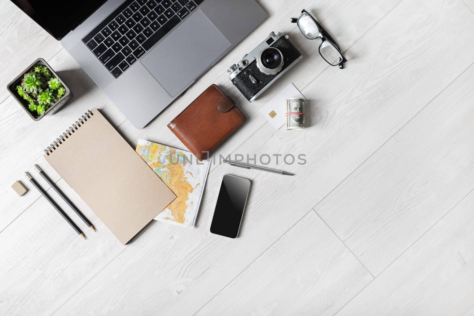 Blank stationery, laptop and travel accessories with copy space. Flat lay.