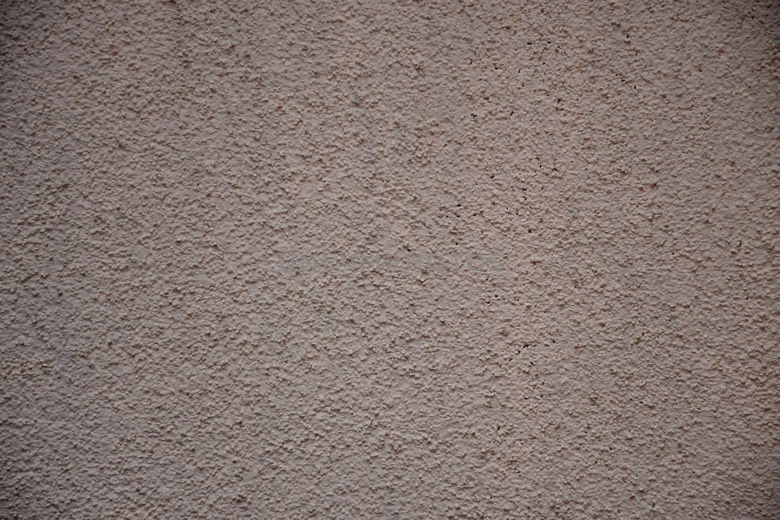Wall of concrete with pink plastering