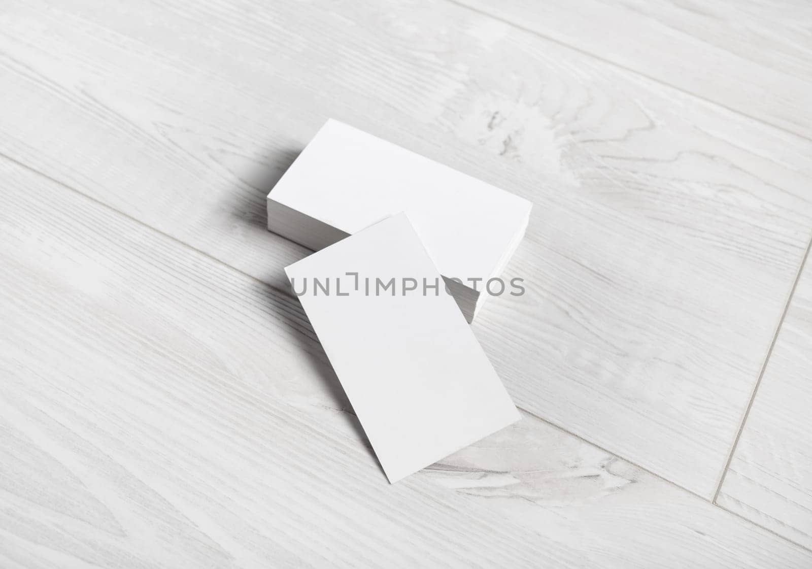 Business cards mockup. Photo of blank business cards on wooden background.