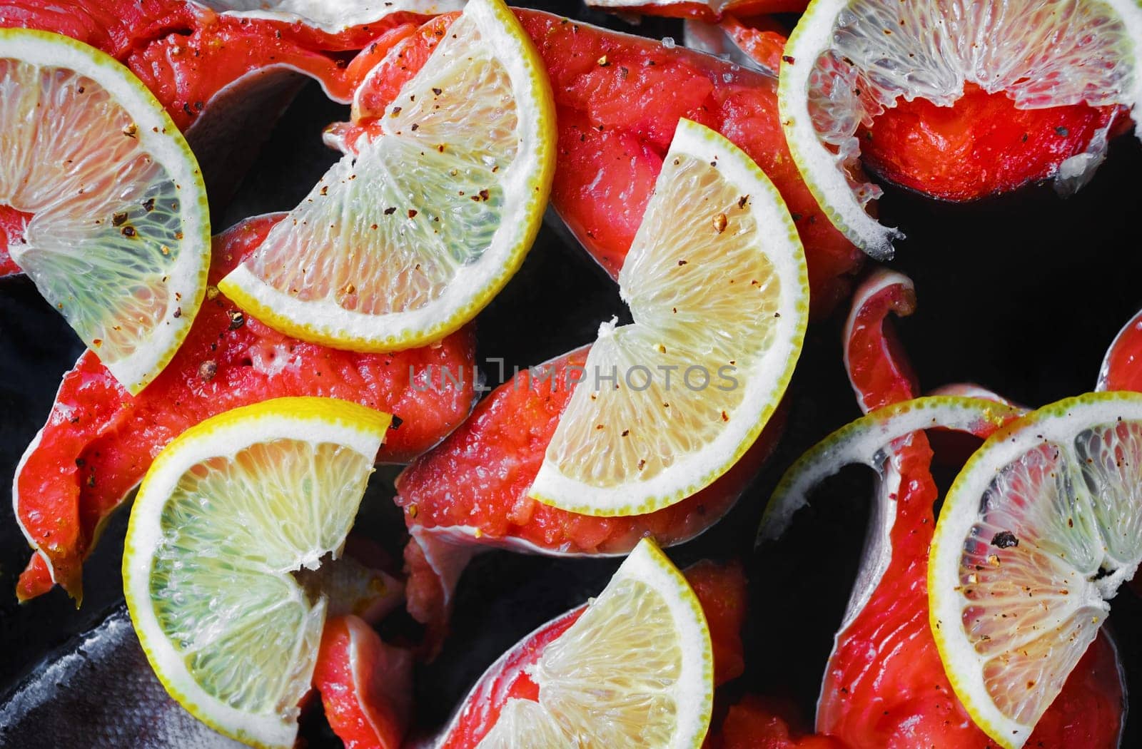 Fresh salmon fish with lemon and seasoning.