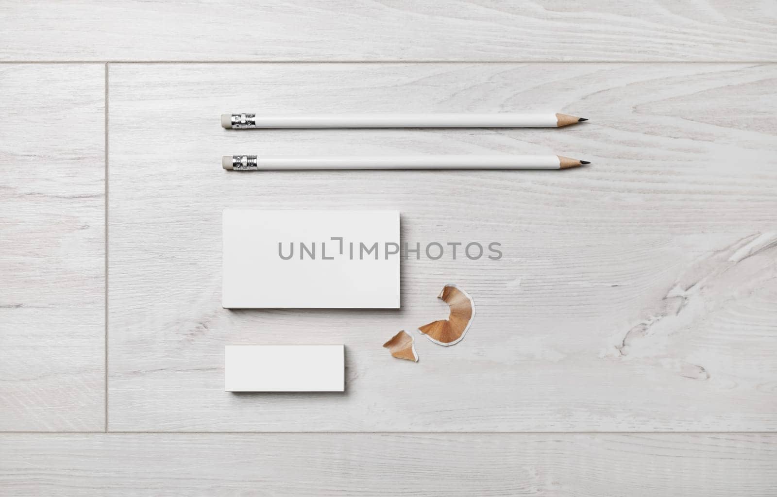 Blank stationery set. Blank business card, pencils and eraser on wood background. Flat lay.