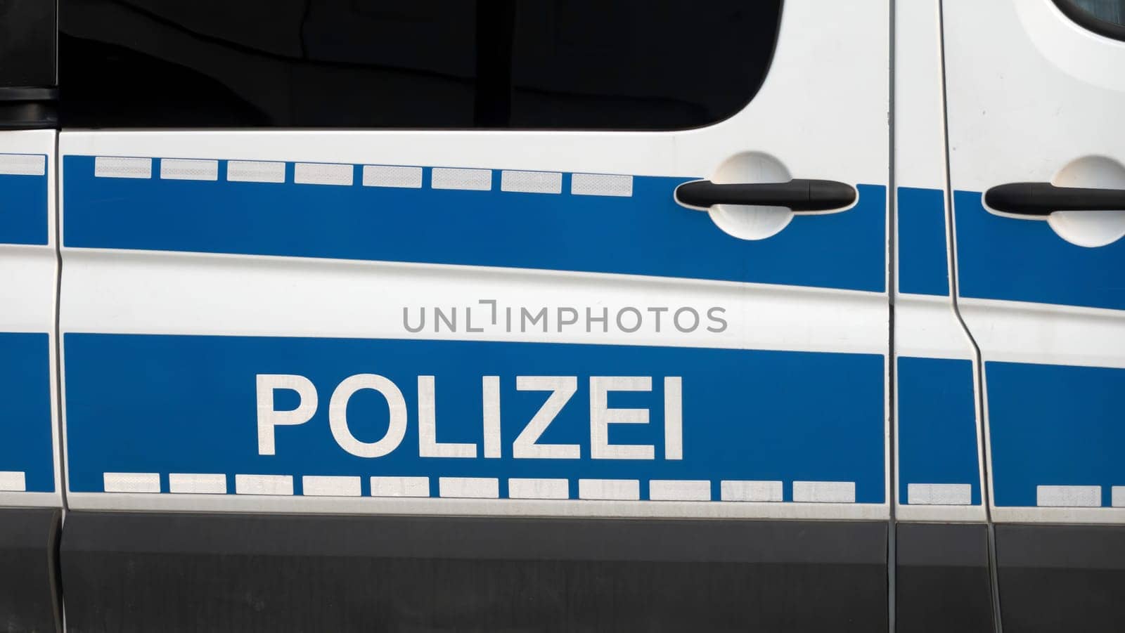 WETZLAR, GERMANY - 2020-12-27: Side view of a typical german police car with lettering "Polizei"" on blue background. Wetzlar, Germany"